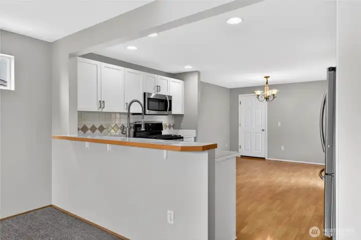 KITCHEN with DINING AREA  Open and spacious work space, with tile backsplash  High bar at sink area, with spray faucet