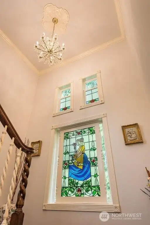 Beautiful window adds a special touch to the stair landing.