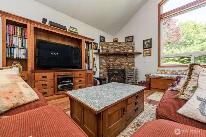 Plenty of room for lounging in the guest house great room with a cozy corner fireplace.