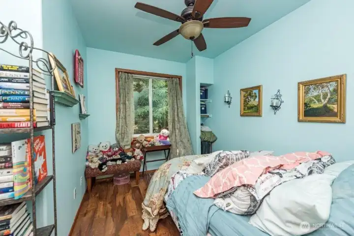 Additional guest house bedroom with a ceiling fan for added comfort.