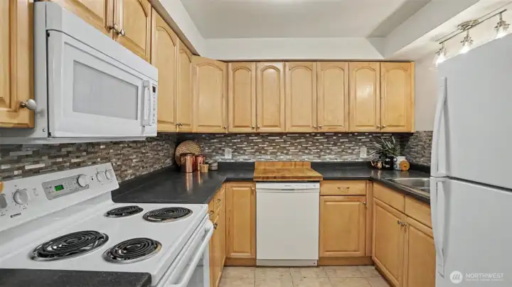 The full size kitchen offers necessary appliances, which remain with the home. The full size kitchen offers necessary appliances, which remain with the home.