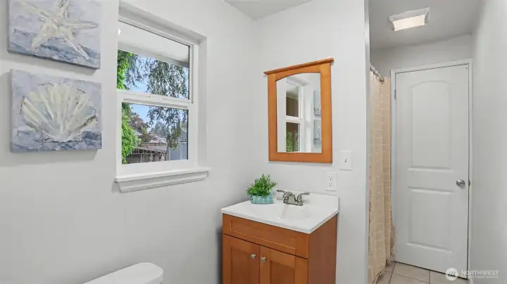 The half-bathroom is located off of the laundry room, adjacent to the dining room. The half-bathroom is located off of the laundry room, adjacent to the dining room.