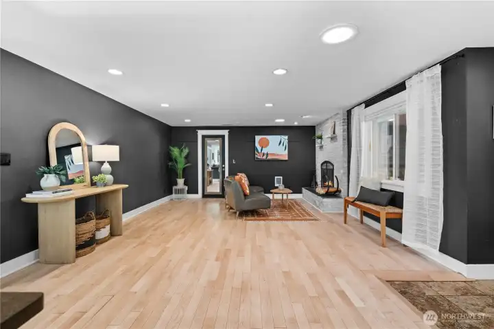 Foyer and living room centered around a real wood-burning fireplace