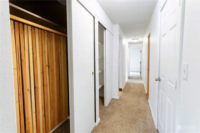 Hallway, garage door on left.  3 beds and bath down hall