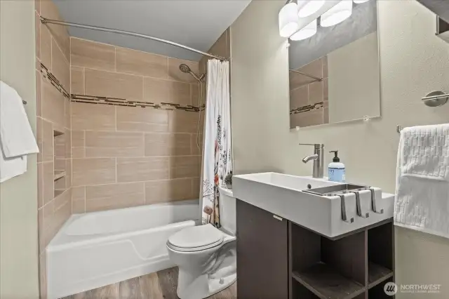 Newly updated bathroom with new tile work, vanity and new toilet.
