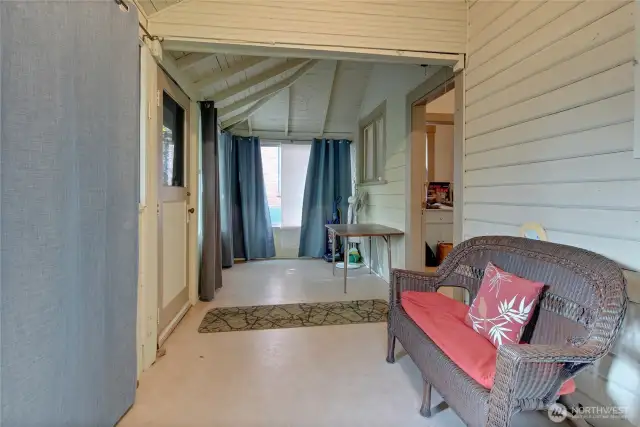 Off of the kitchen in Unit A is a large covered back porch/sunroom that leads to the back yard.