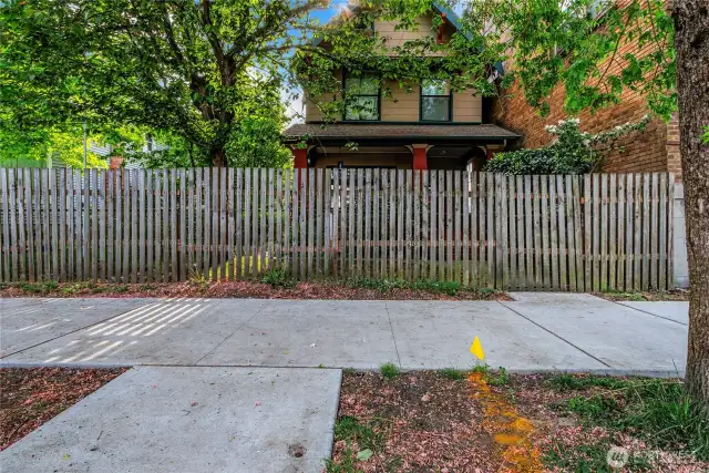 Street view showing the fenced front yard.