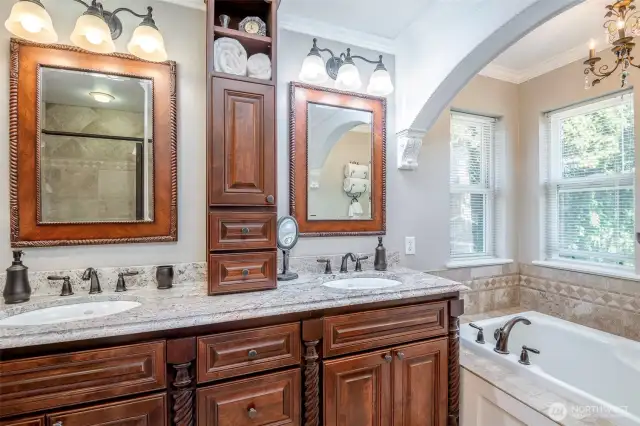 Updated primary5 piece bathroom suite with soaking tub, custom vanity, granite counters and tiled mud pan shower system