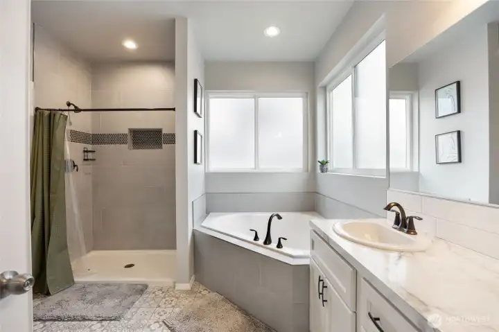 Primary bath with tiled shower, corner tub and Dual Vanity