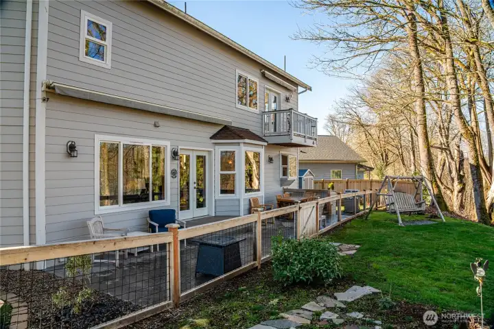 Fenced patio area with huge retractable awning.
