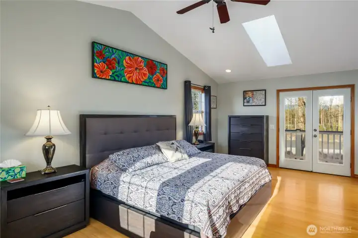 Primary bedroom with skylight, and sitting area.