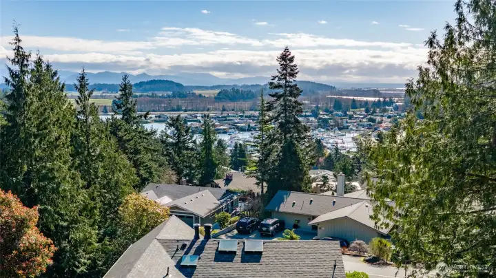 A birds-eye view of Shelter Bay and Skagit Valley reaches across the channel, through the farmlands, and rises to the peaks of this recreational wonderland. Come visit in early morning at dusk or moon-rise and see the magic!