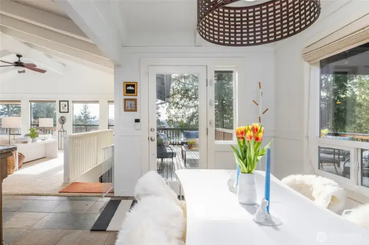 Find easy access for outdoor entertaining through the glass French door leading from the kitchen to both covered and uncovered outdoor view decks.