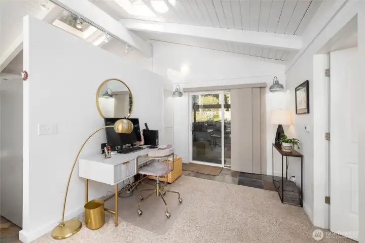 Flexible bonus space off the carport—perfect for a home office, studio, or formal dining area. Slate tile flooring and plush wall-to-wall carpet too.