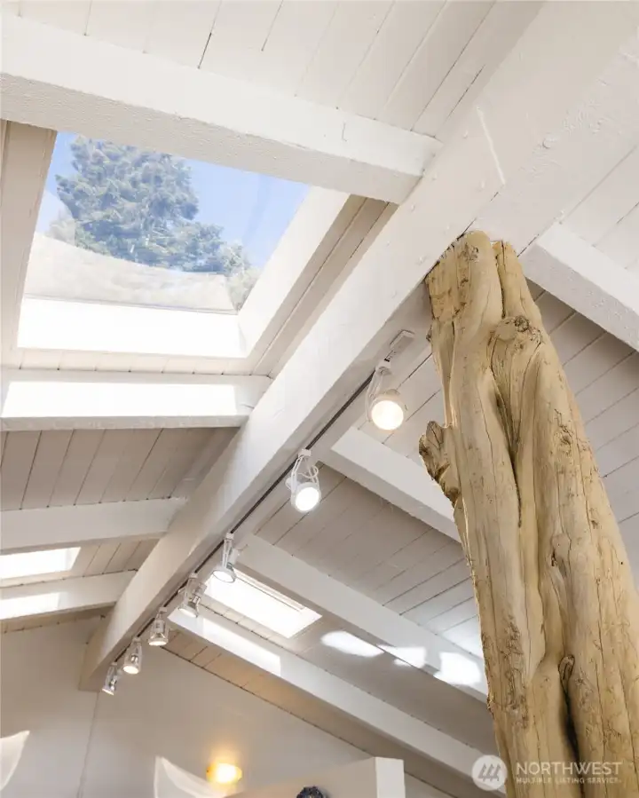 The handcrafted tree trunk support beam adds a unique, nature-inspired focal point.