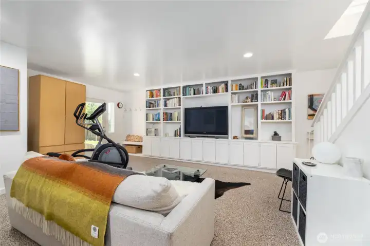 Display collections or collectibles in the built-in shelving or house your game day big screen in the lower living space.