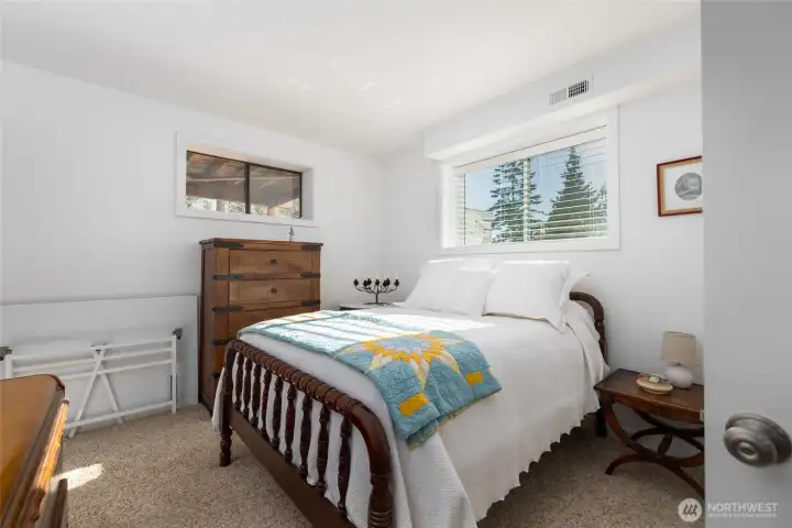 The third bedroom, one of two on the lower living level, enjoys morning light and could also function as an office, yoga space, music room or much more!