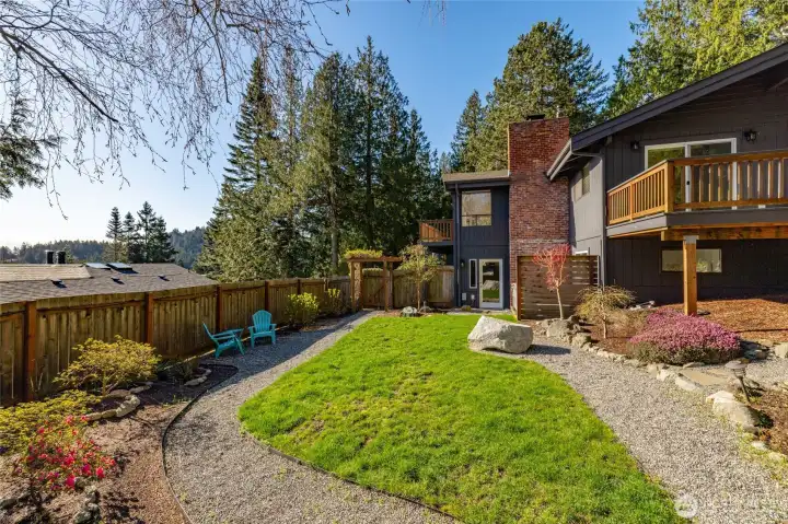 The fully fenced backyard is ready for gardening, your pet, and more with a nice lawn, large tool shed and hot tub too.