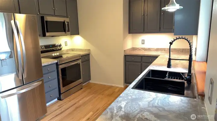 Stylish new countertops, refreshed cabinets, new sink, stainless appliances