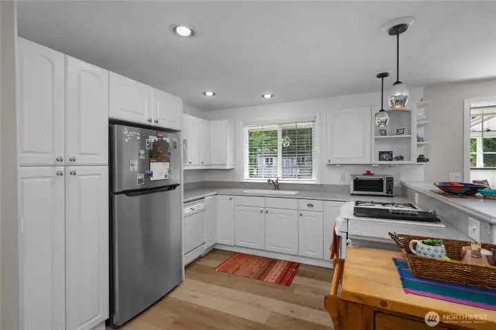 Kitchen with new appliances, new lighting, and undermount lights.