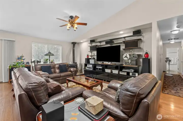 Living room with vaulted ceilings, wood stove.
