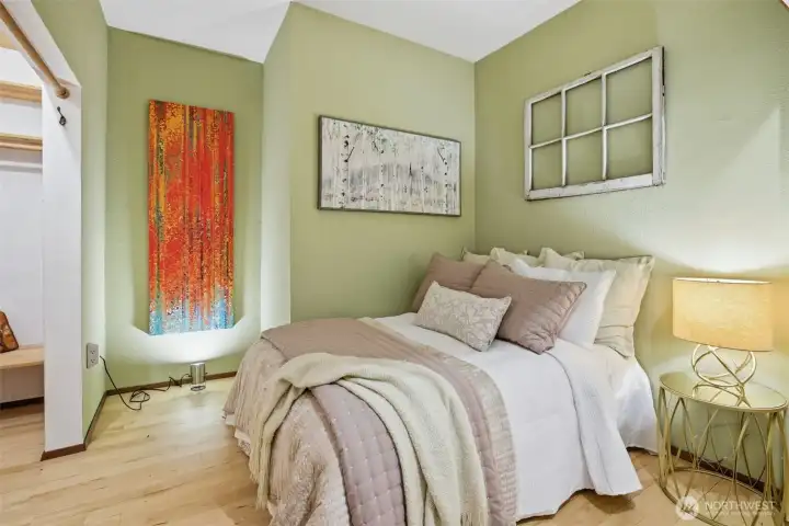 Spacious bedroom designed for rest and privacy. With no exterior windows, the space offers complete light control, creating a naturally dark environment that supports deeper sleep and a calm, relaxed feel.