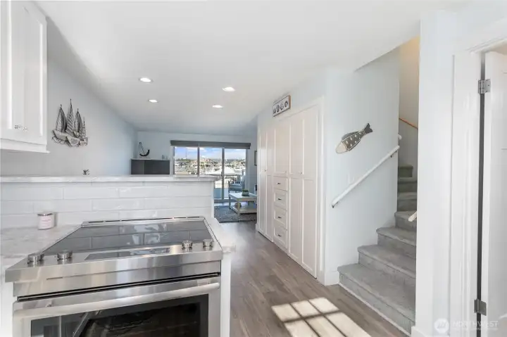 White cabinets on right of picture provide tons of storage and the washer and dryer