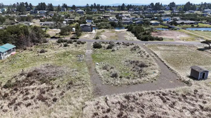 Future building site located at end of u shaped driveway providing easy access for construction.