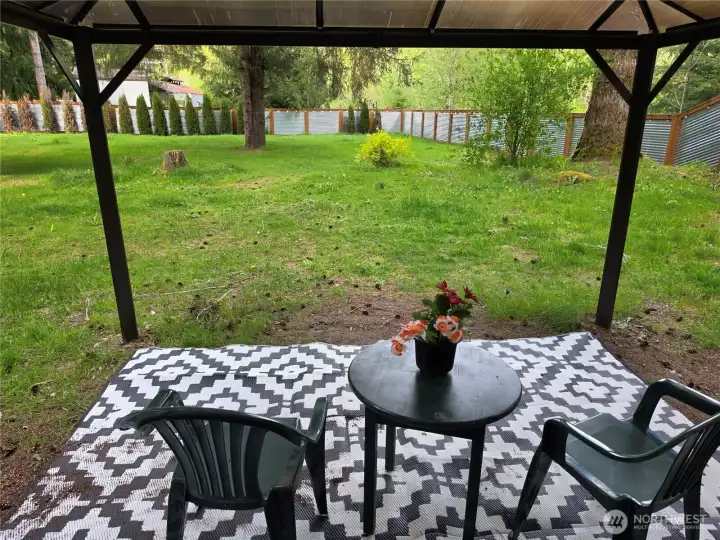 The gazebo allows you to stay dry as you enjoy the back yard.