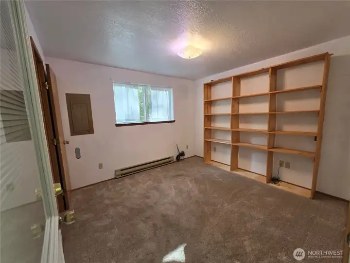 Also downstairs is a smaller bedroom with more shelves and a walk-in closet.