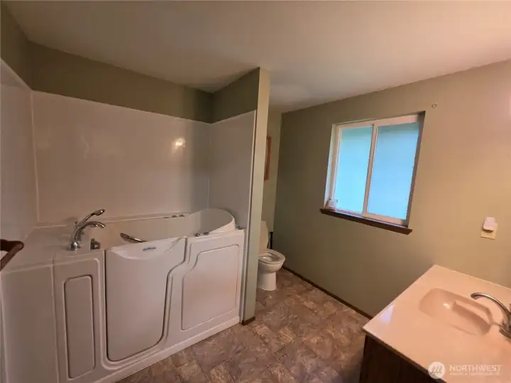 The upstairs bath has this amazing walk in tub with a handheld shower so it will make the whole family happy...and keep them clean!