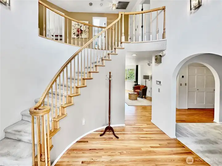 Dramatic entry with refinished hardwood flooring.
