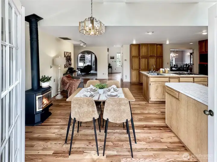 Looking from deck into kitchen nook area. Island with second sink and large pantry cabinets.