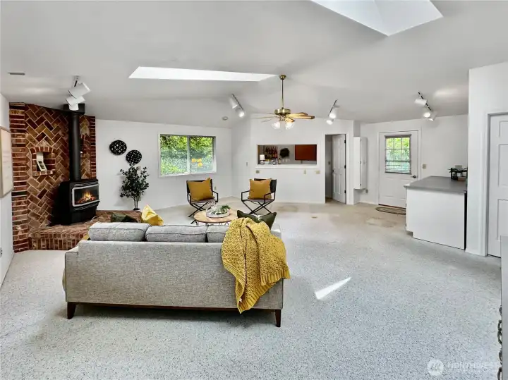 Huge family/rec room with access to rear yard.  Freestanding propane stove keeps things cozy.  Skylights let in lots of light.