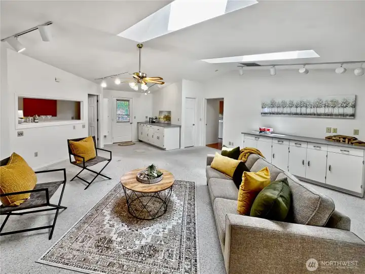 Looking towards entrance to family room, 1/2 bath just as you enter, cut out with room behind makes the perfect bar.  Lots of possibilities!