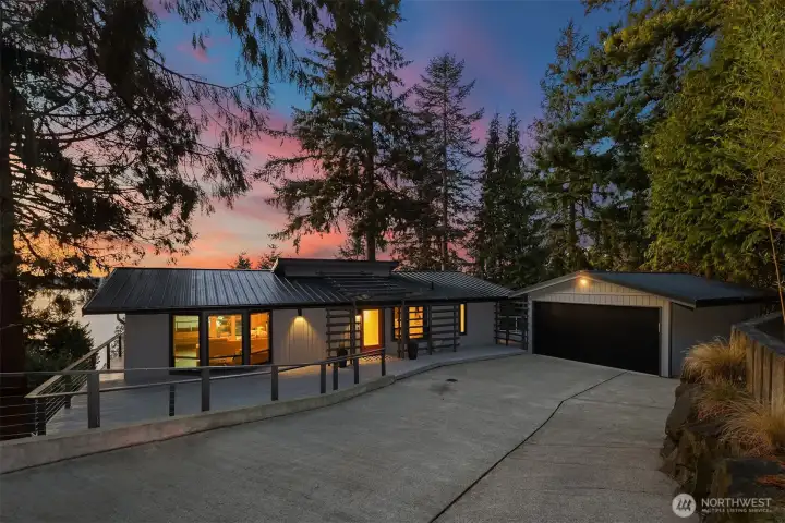 Detached garage with metal roof and custom metal door for durability and character.