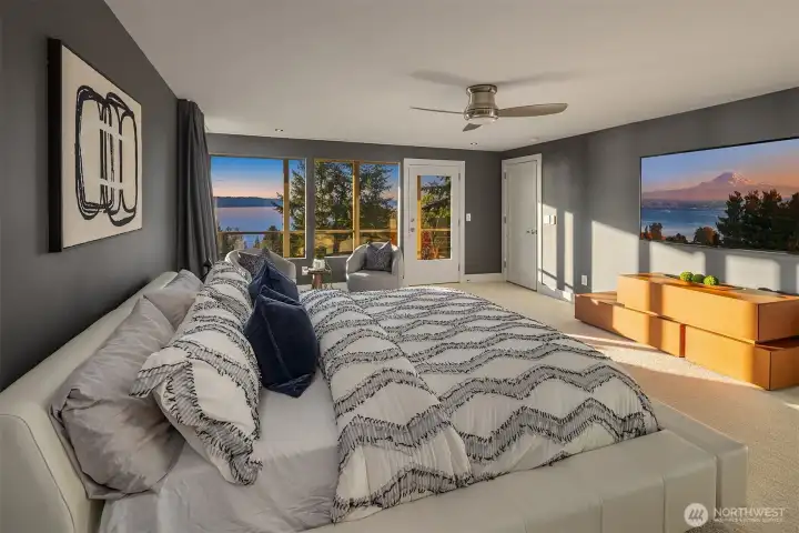 Quiet primary suite with blackout curtains and deck access to Sound views