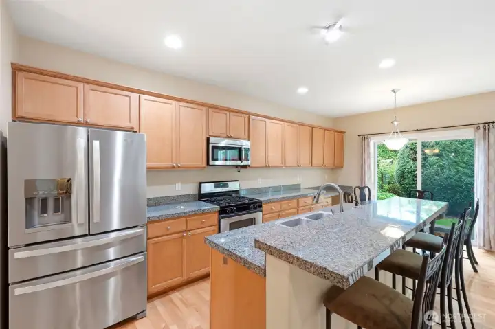 The kitchen has room for a dining table and counter for barstools.