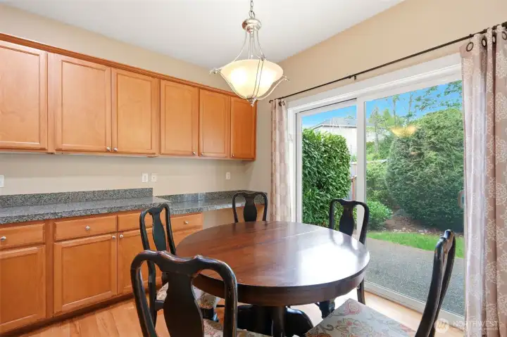 The dining area in the kitchen has sliding doors to the backyard patio for easy grilling and entertaining.