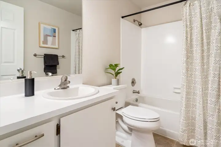 A second full bath further down the hall doubles down on convenience.