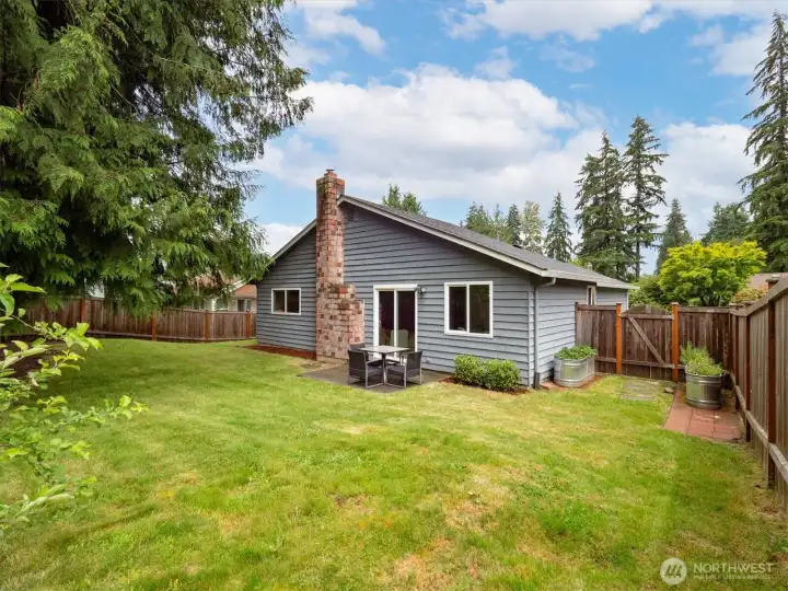 A look back at the house from the fully fenced backyard.