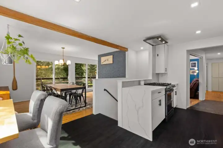 Quartz countertops with a waterfall edge and gas cooktop. Quartz countertops with a waterfall edge and gas cooktop.