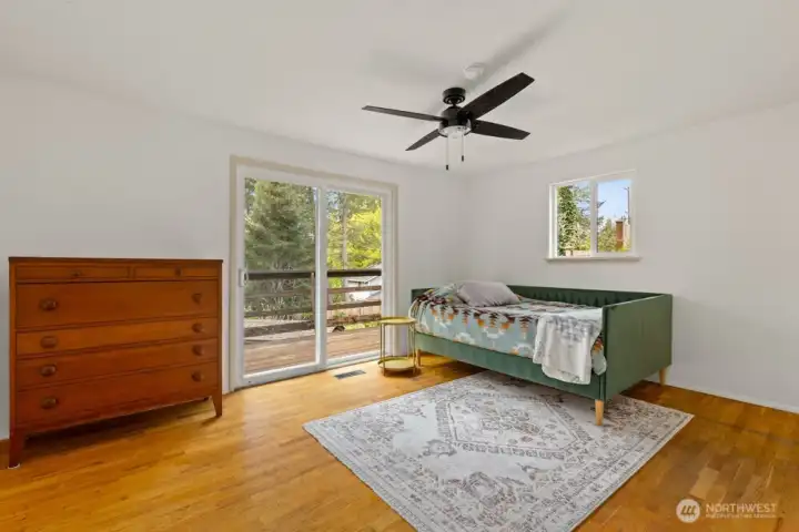 Main floor primary with original oak floors and slider to deck. Main floor primary with original oak floors and slider to deck.