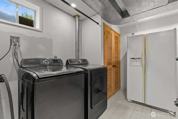 Generous laundry room with storage space and a fridge that stays. Generous laundry room with storage space and a fridge that stays.