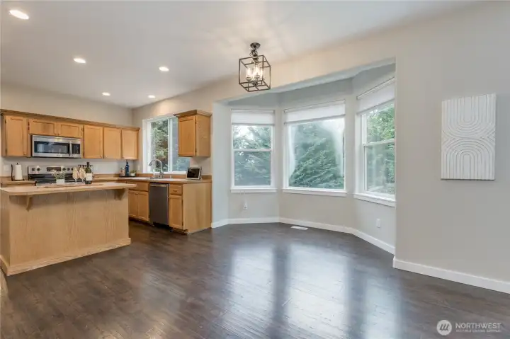 Casual dining space with bright bay window overlooking the backyard