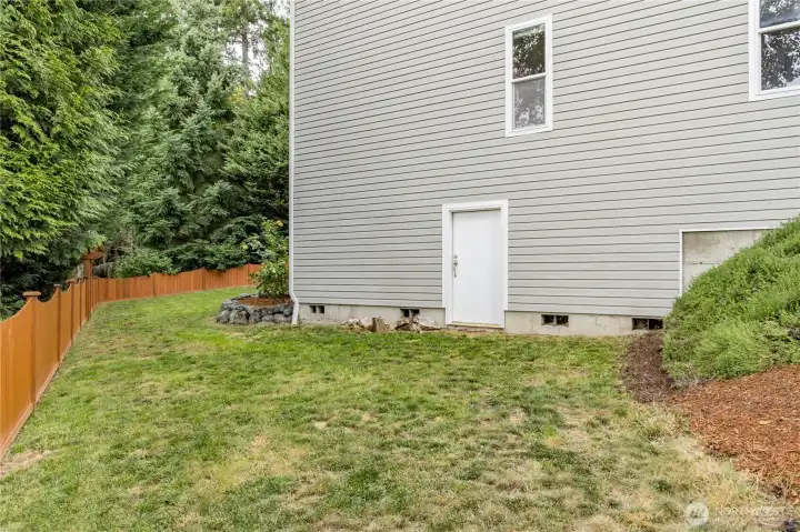 Side yard provides access to the extensive crawlspace