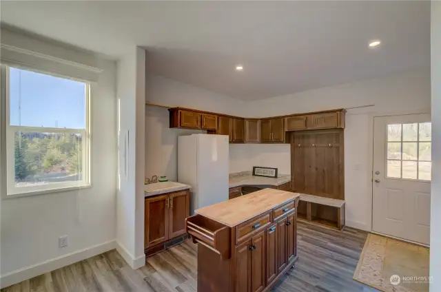 Another view of laundry room showing freezer and sink