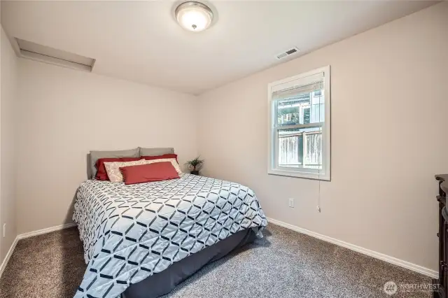 2nd bedroom on main level. Queen bed shown (room is bigger than looks in picture)