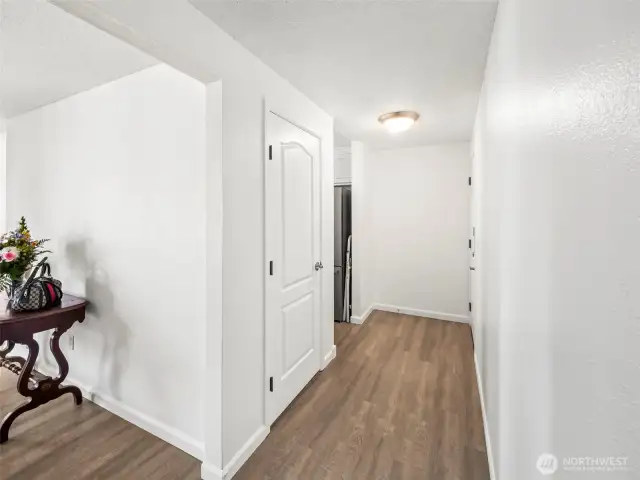 Hallway from Bedrooms onlooking towards Living Room, Hallway Closet, then Kitchen