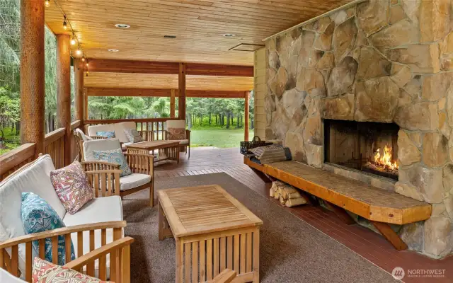 Enjoy outdoor living by the cozy outdoor wood fireplace.